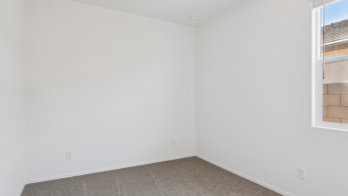 Comfortable guest bedroom featuring neutral-toned walls and a large closet.