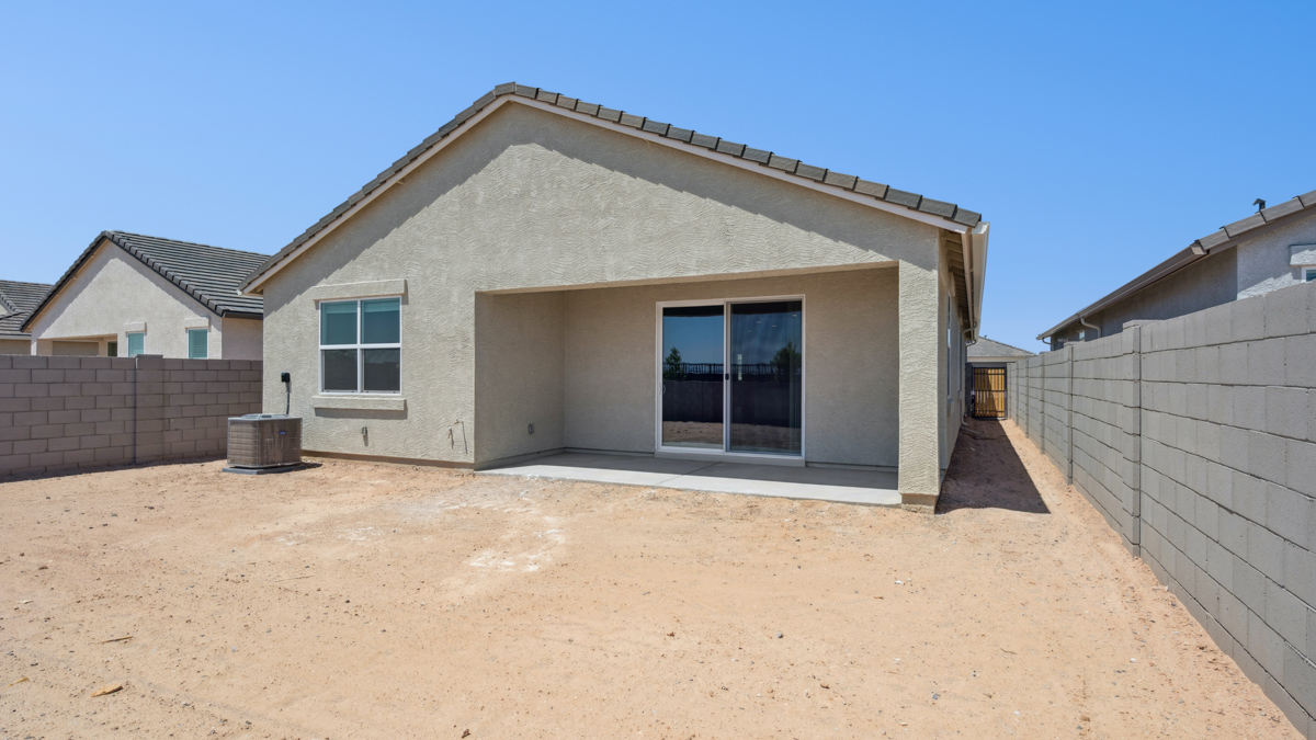 Large fenced-in backyard with a covered patio, perfect for outdoor entertaining.