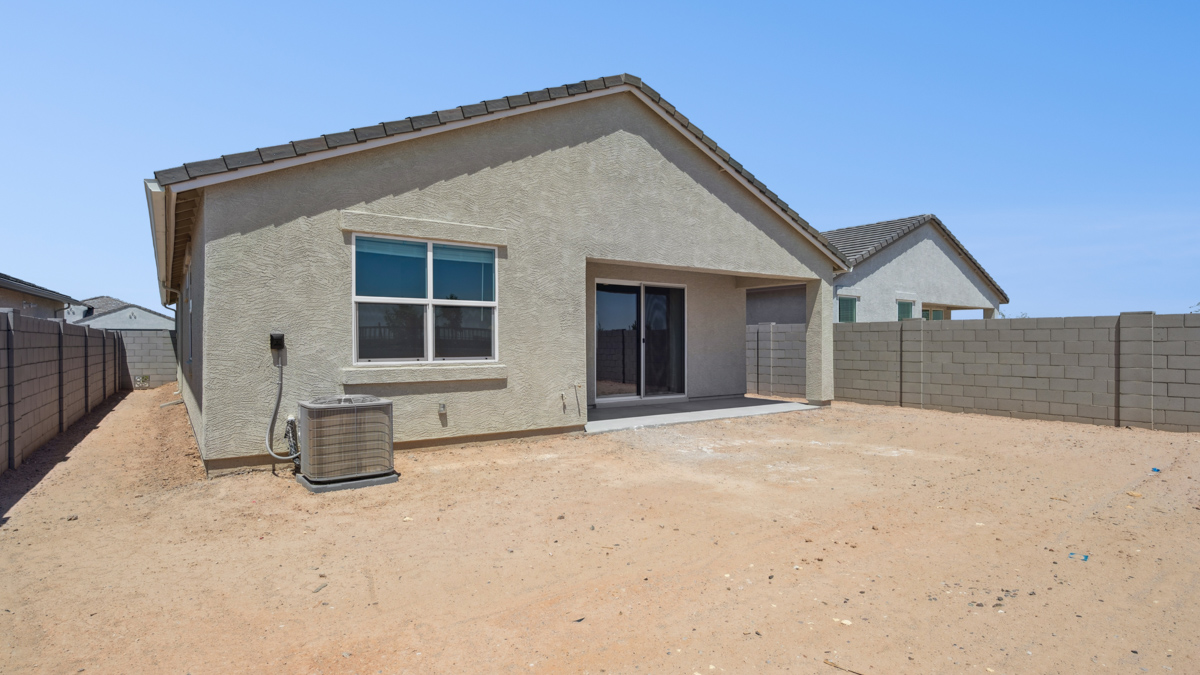 Large fenced-in backyard with a covered patio, perfect for outdoor entertaining.