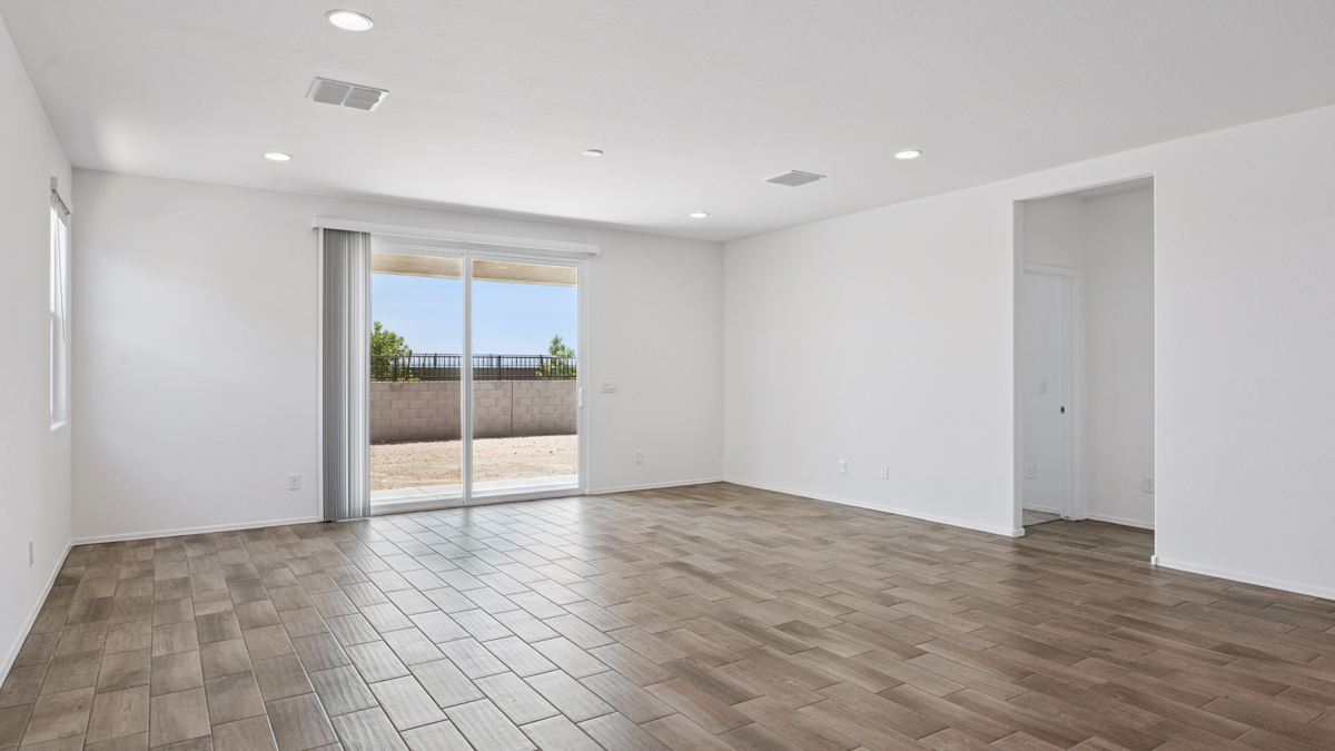 A well-organized living room that includes a kitchen and dining area, creating a warm and welcoming environment for gatherings.