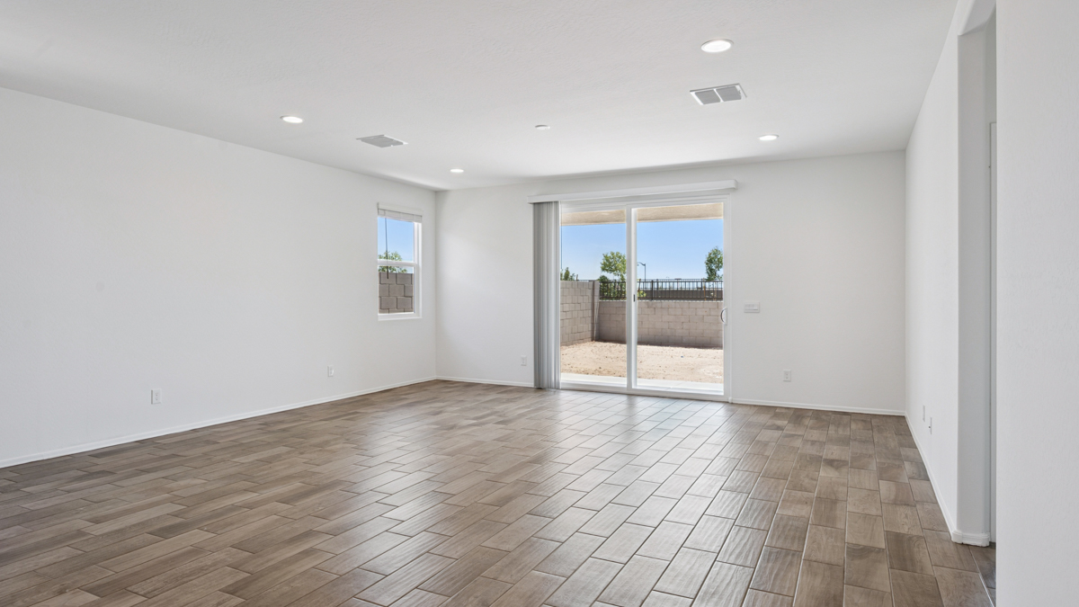 A well-organized living room that includes a kitchen and dining area, creating a warm and welcoming environment for gatherings.