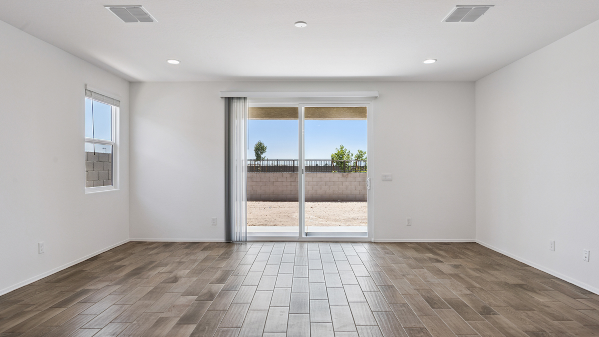 A well-organized living room that includes a kitchen and dining area, creating a warm and welcoming environment for gatherings.