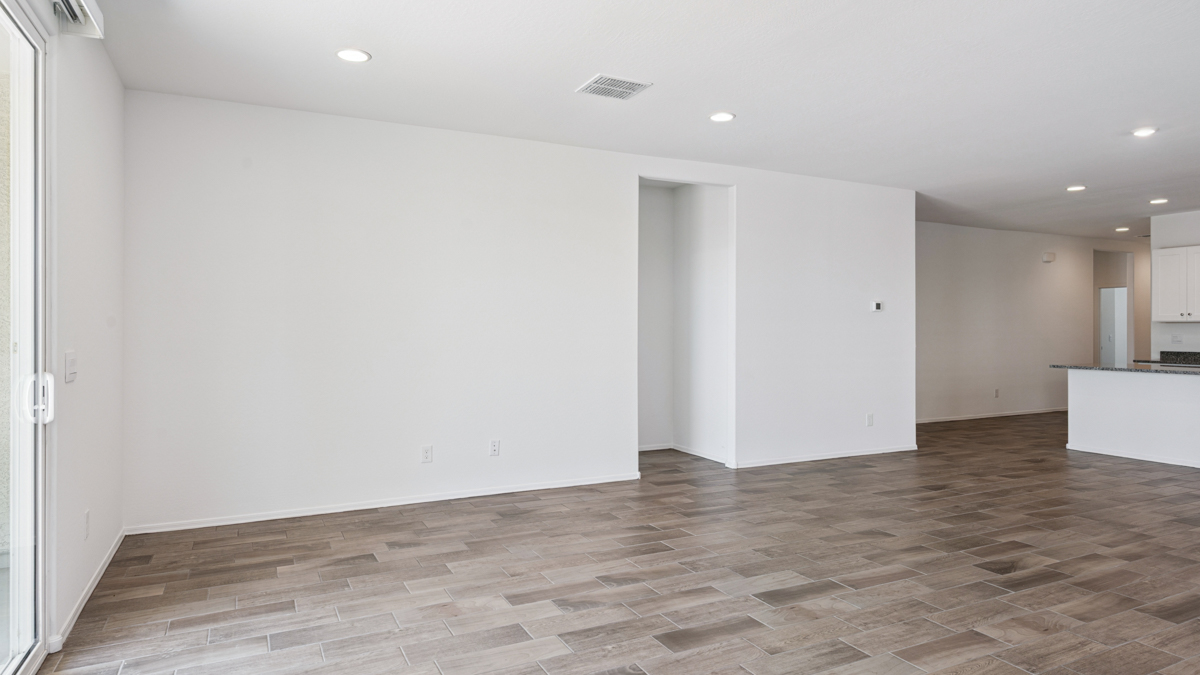 A well-organized living room that includes a kitchen and dining area, creating a warm and welcoming environment for gatherings.