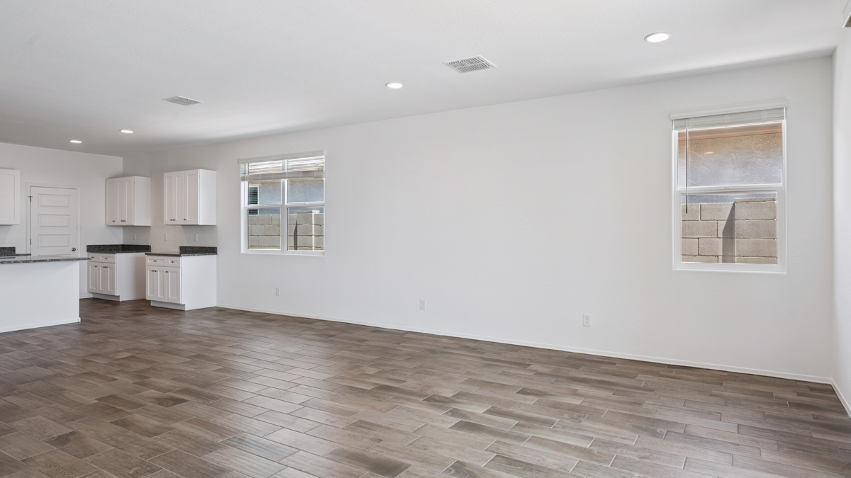 A well-organized living room that includes a kitchen and dining area, creating a warm and welcoming environment for gatherings.