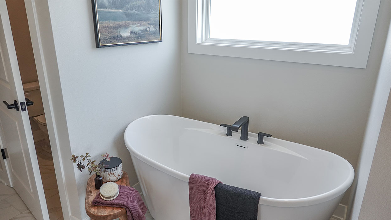 Spacious bathroom with white cabinetry and double sinks