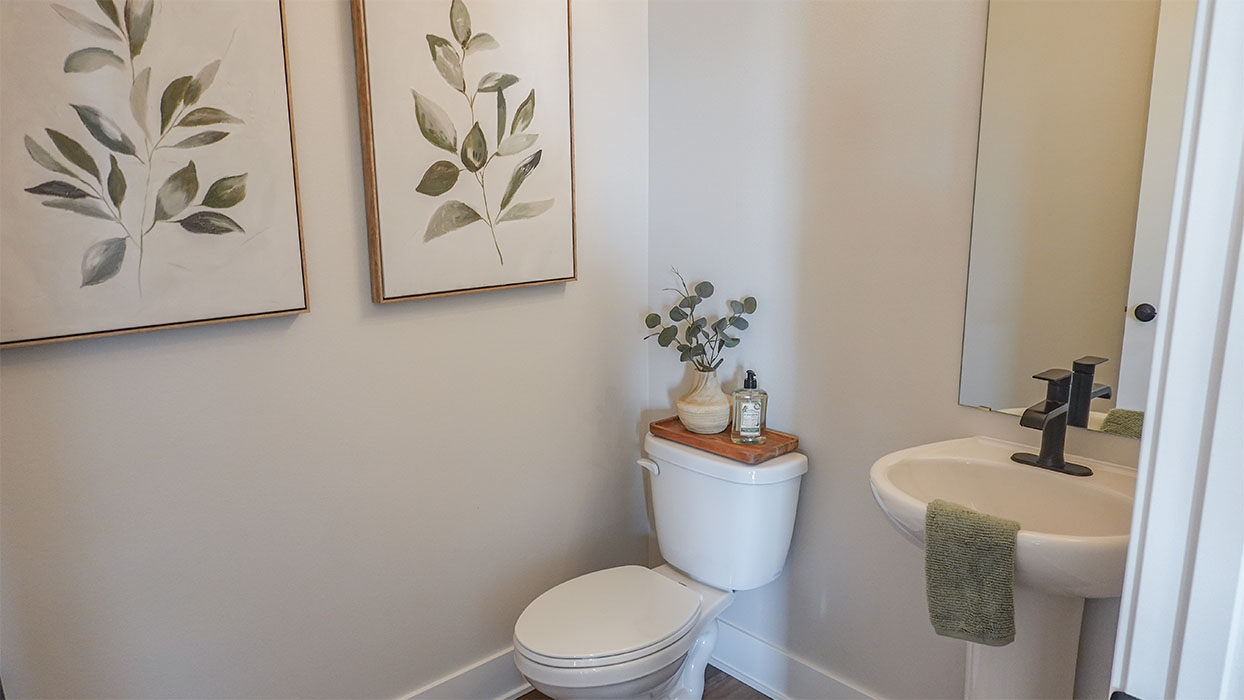 Convenient main-level powder room with updated fixtures and bright lighting.