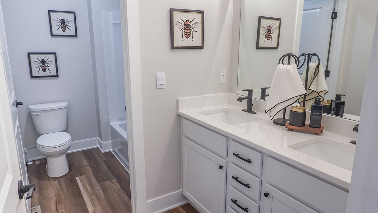 Bathroom with tub and shower combo, quartz countertops, and white vanity