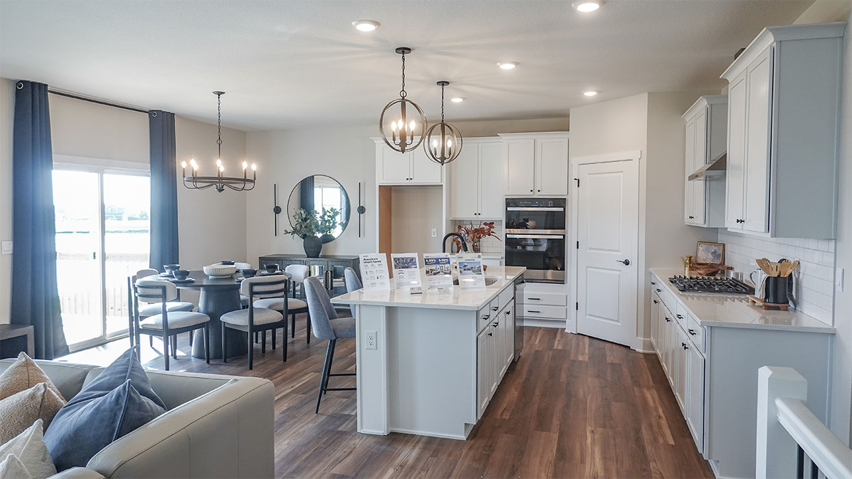 Kitchen with stainless steel appliances, quartz countertops, and white cabinetry