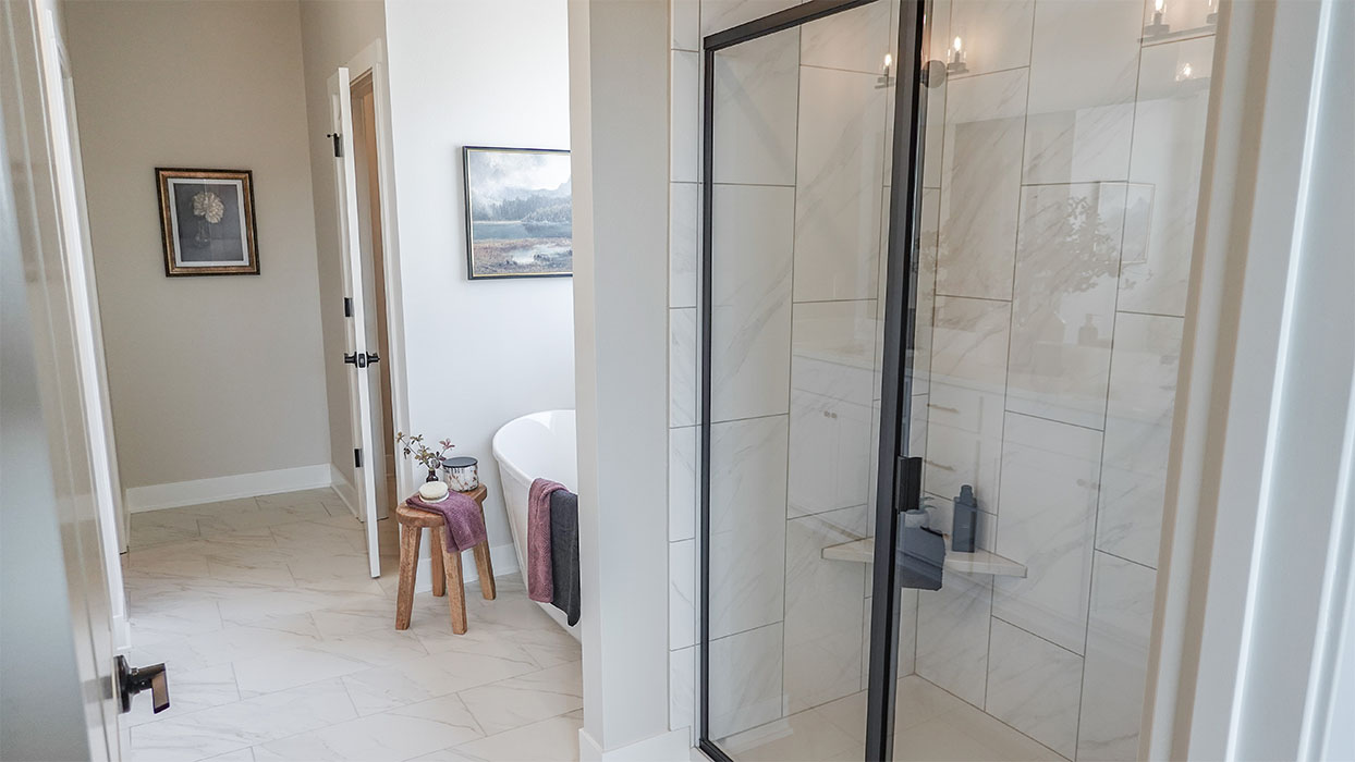 Spacious bathroom with white cabinetry and double sinks