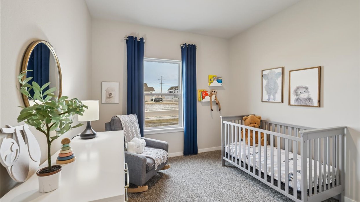 second bedroom with small window staged as a nursery