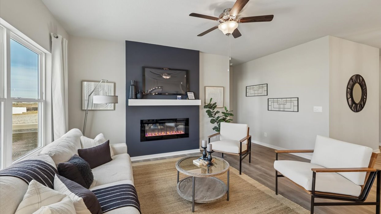 living room with large window and electric fireplace