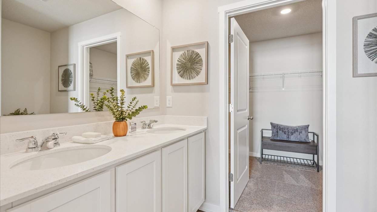 primary bathroom with large mirror and dual sinks