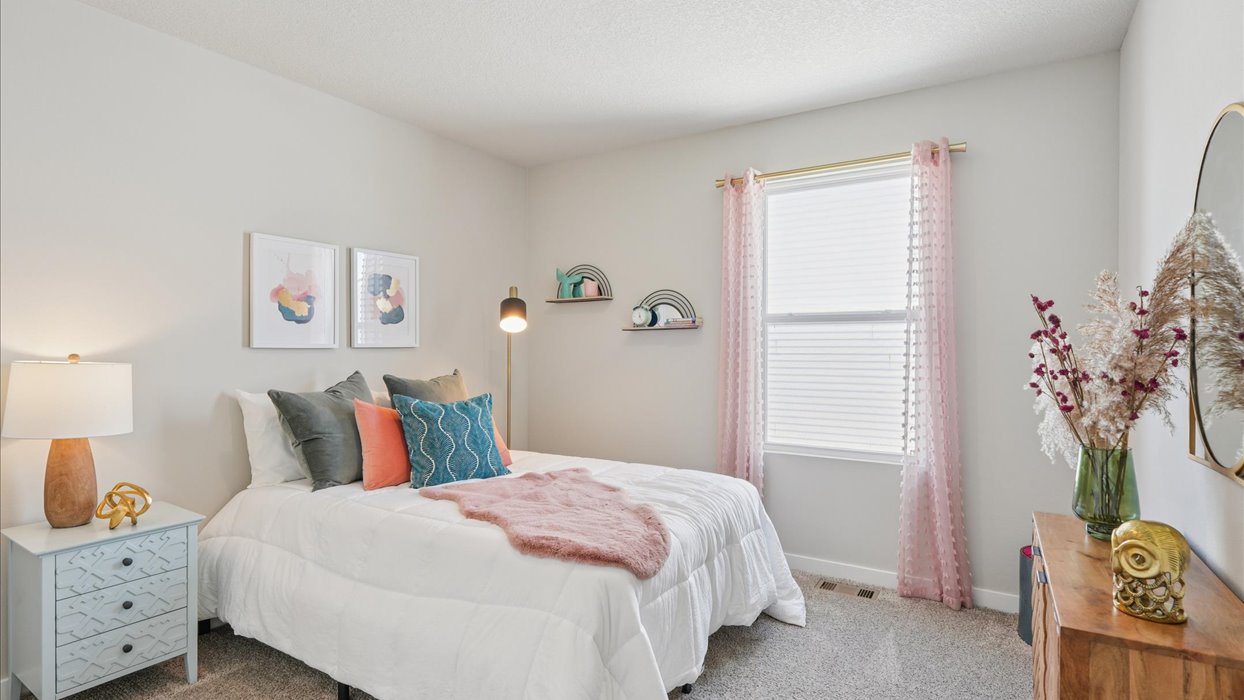 first bedroom with twin bed and small windoe