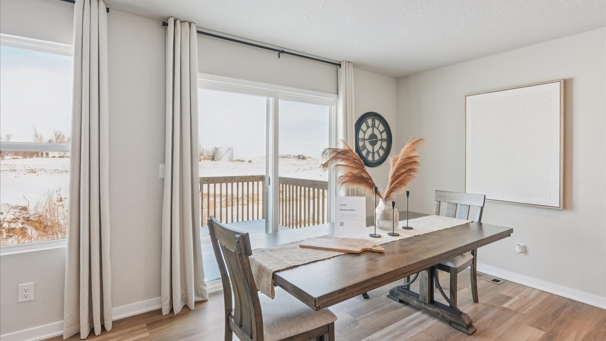 dining room table with wood table and chairs next to sliding glass doors