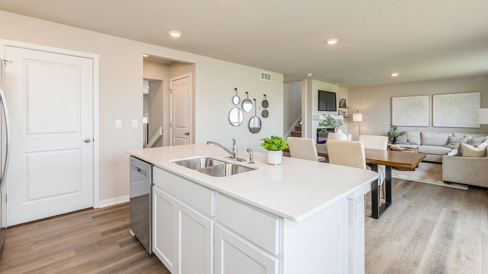Kitchen with stainless steel appliances, quartz countertops, and white cabinetry