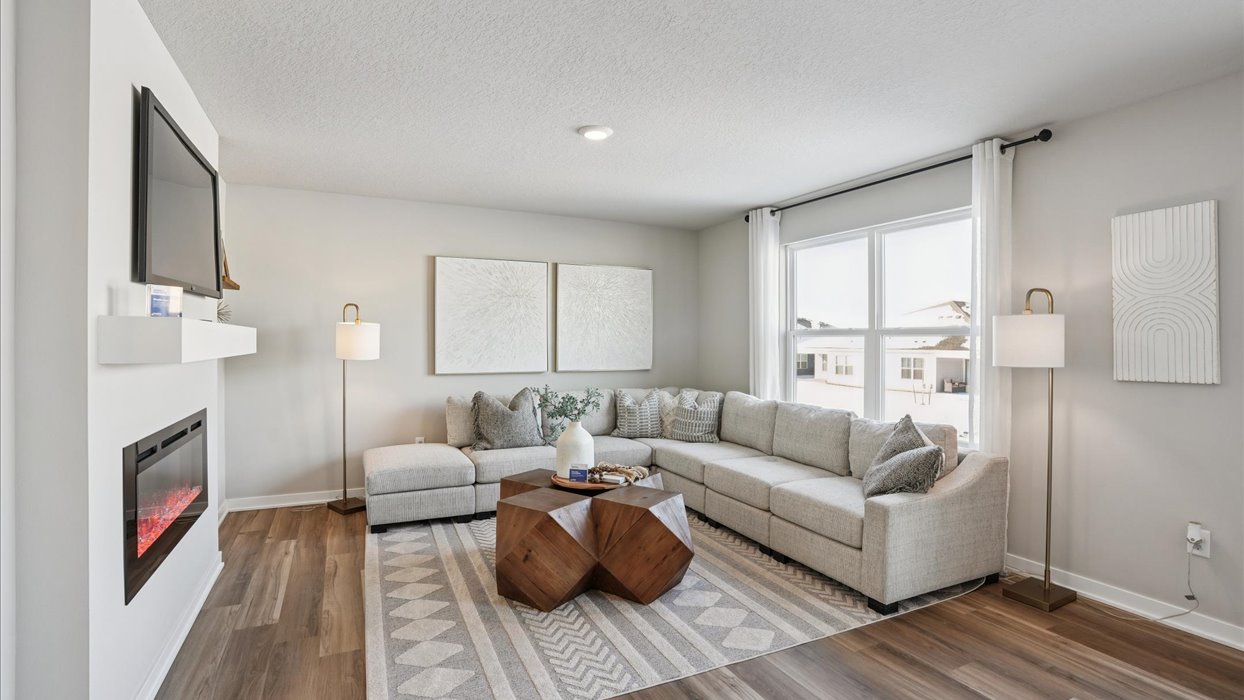 living room with big window and electric fireplace