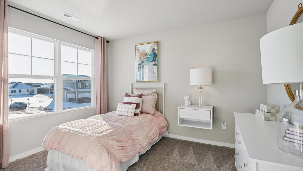 first bedroom with large window and twin bed