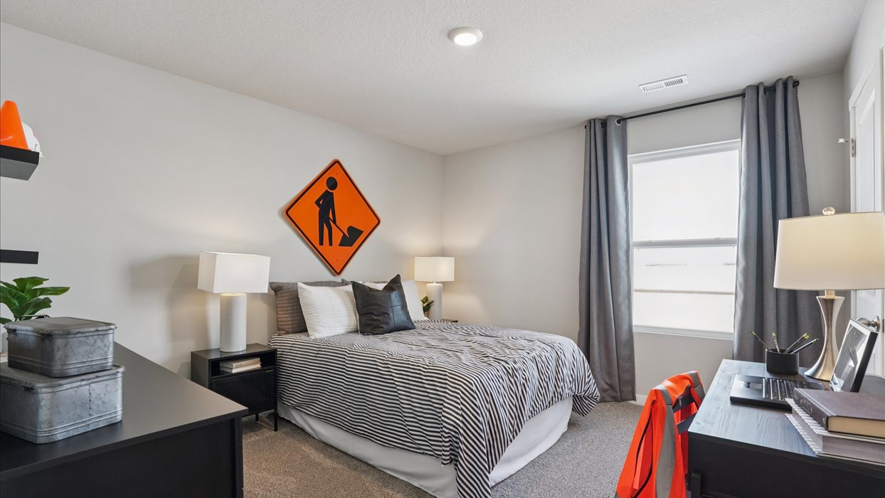 third bedroom with window and furniture