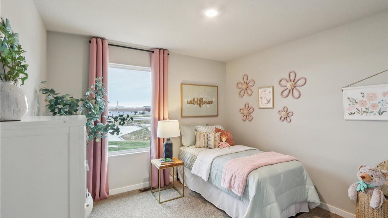 first bedroom with small window and twin bed