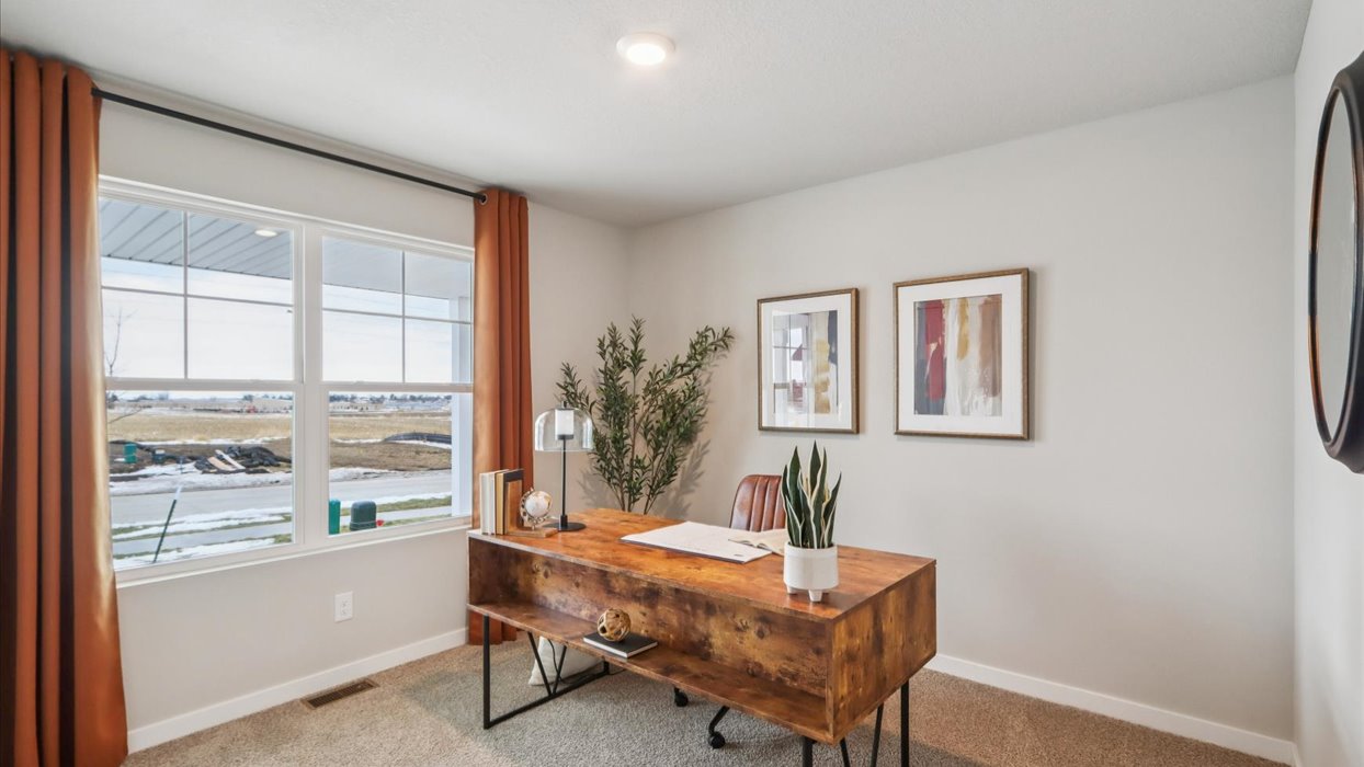 second bedroom staged as an office with large window