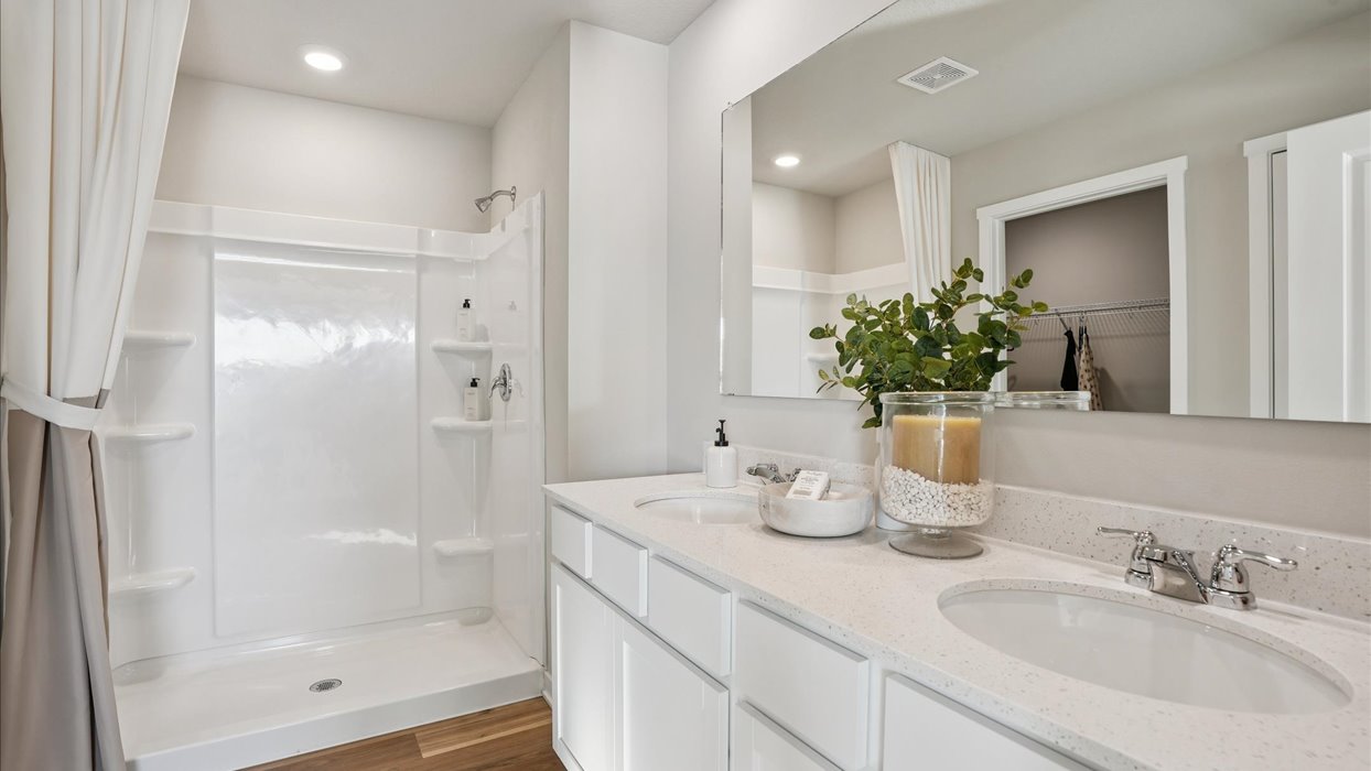 Primary bathroom of the Bellhaven with dual sinks and a walk in shower