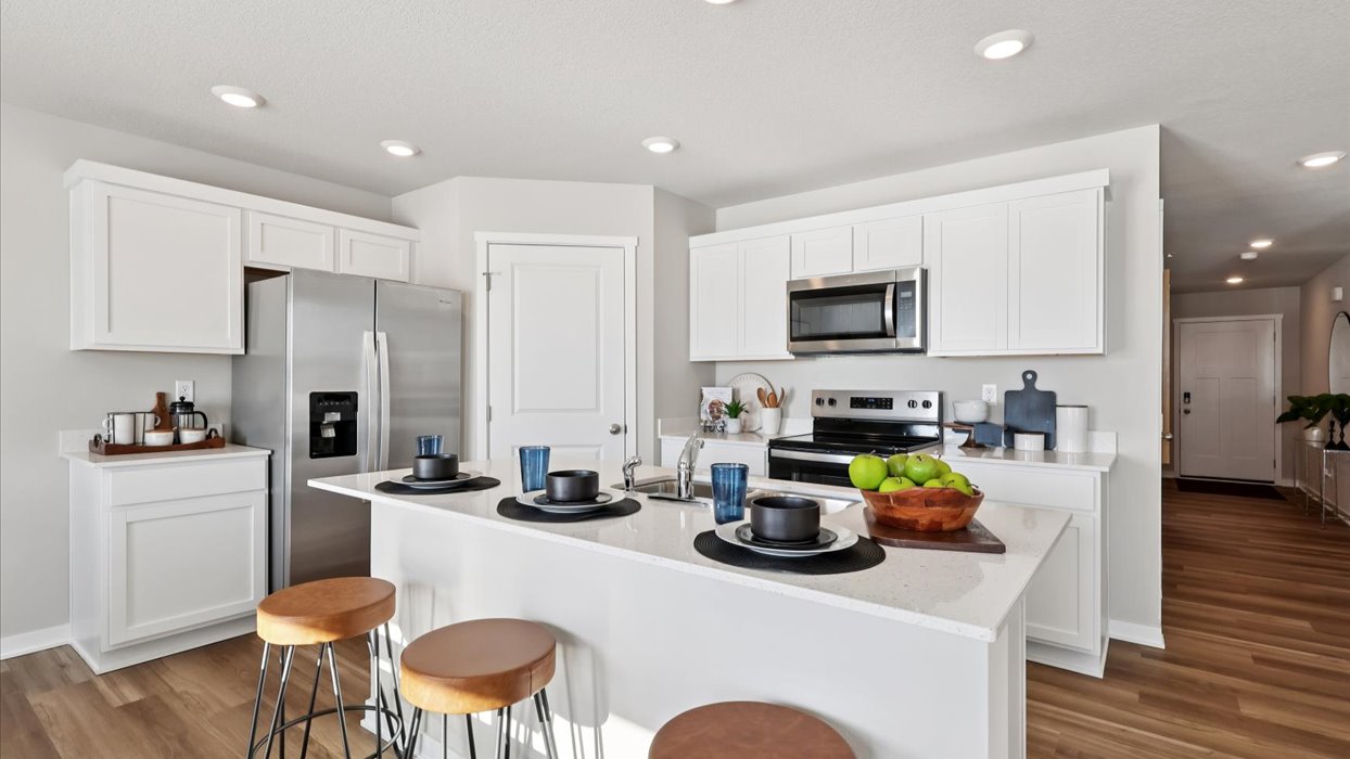 white kitchen with stainless-steel appliances