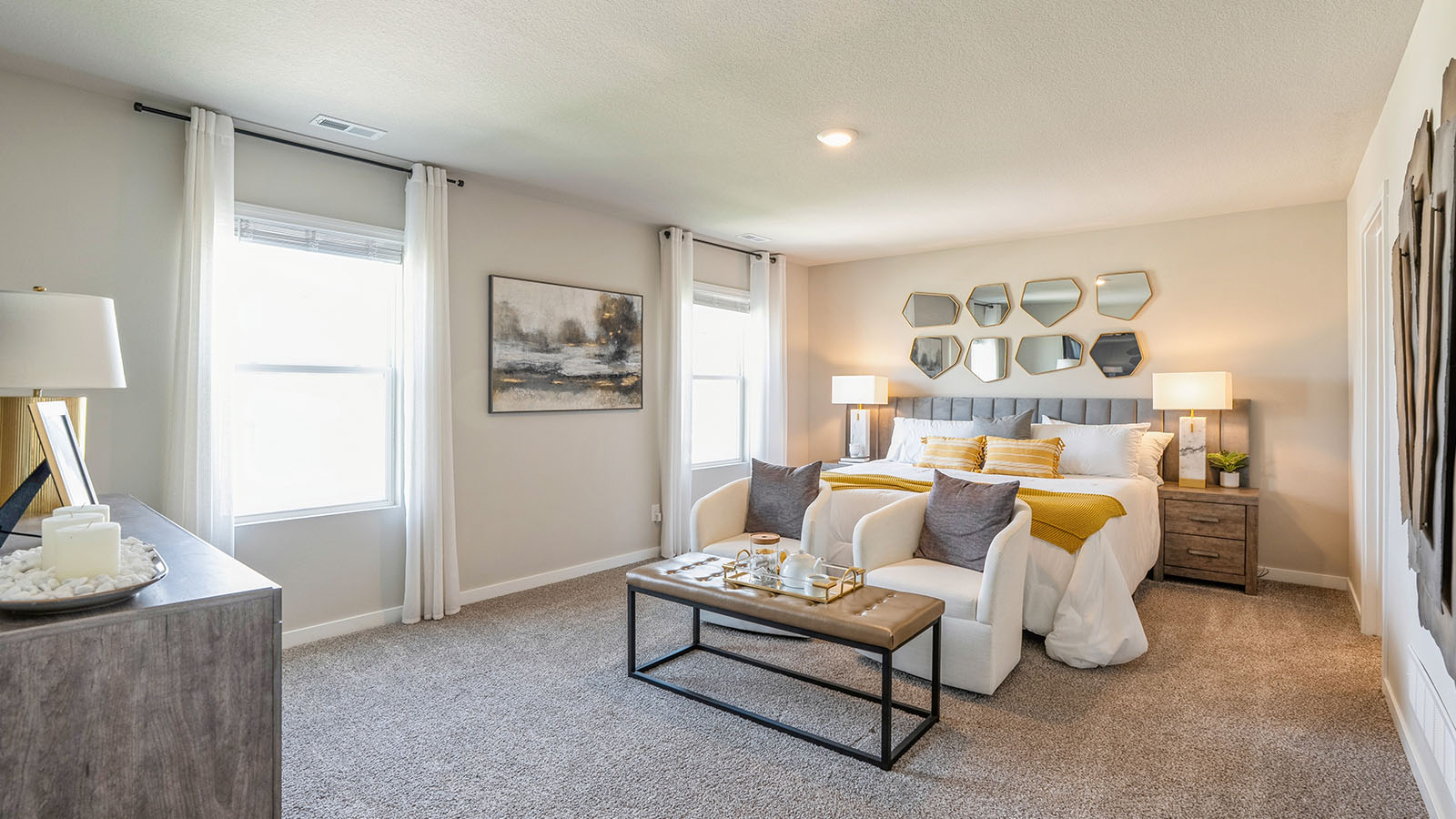 Spacious primary suite with natural light, attached bathroom, & walk in closet