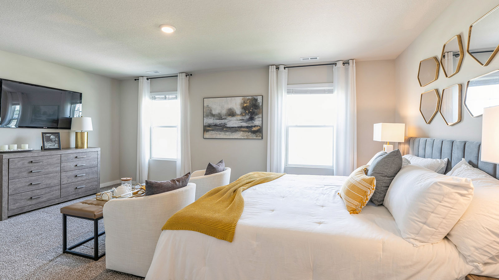 Spacious primary suite with natural light, attached bathroom, & walk in closet