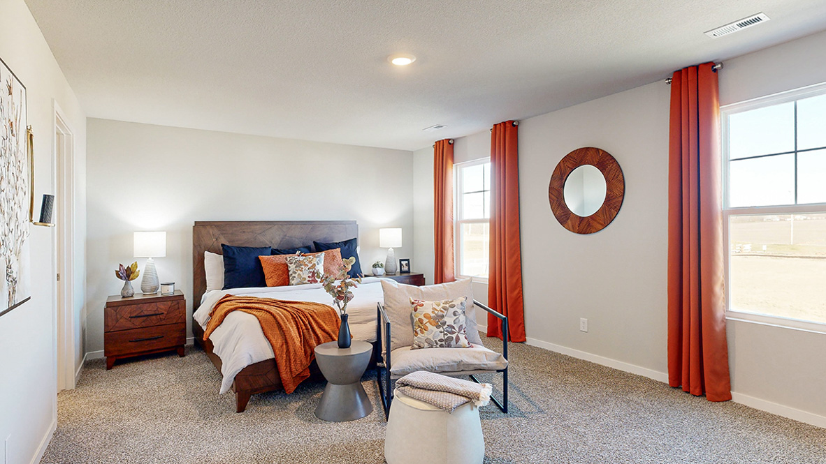 Spacious primary suite with natural light, attached bathroom, & walk in closet