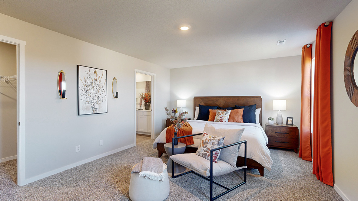 Spacious primary suite with natural light, attached bathroom, & walk in closet