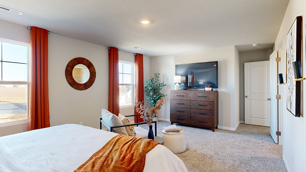 Spacious primary suite with natural light, attached bathroom, & walk in closet