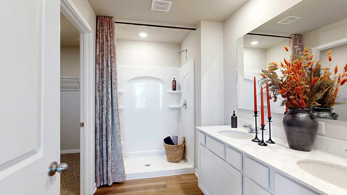 Spacious bathroom with white cabinetry and double sinks