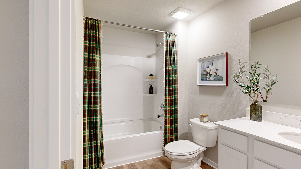 Bathroom with tub and shower combo, quartz countertops, and white vanity