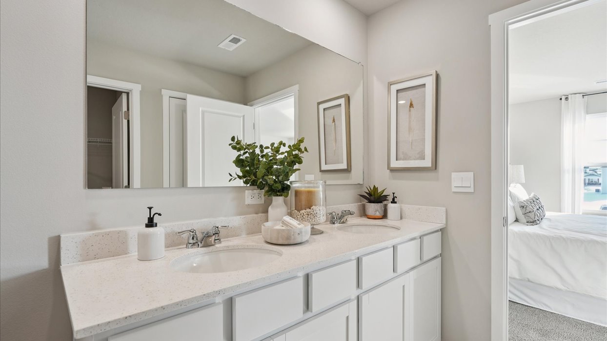 Spacious bathroom with white cabinetry and double sinks
