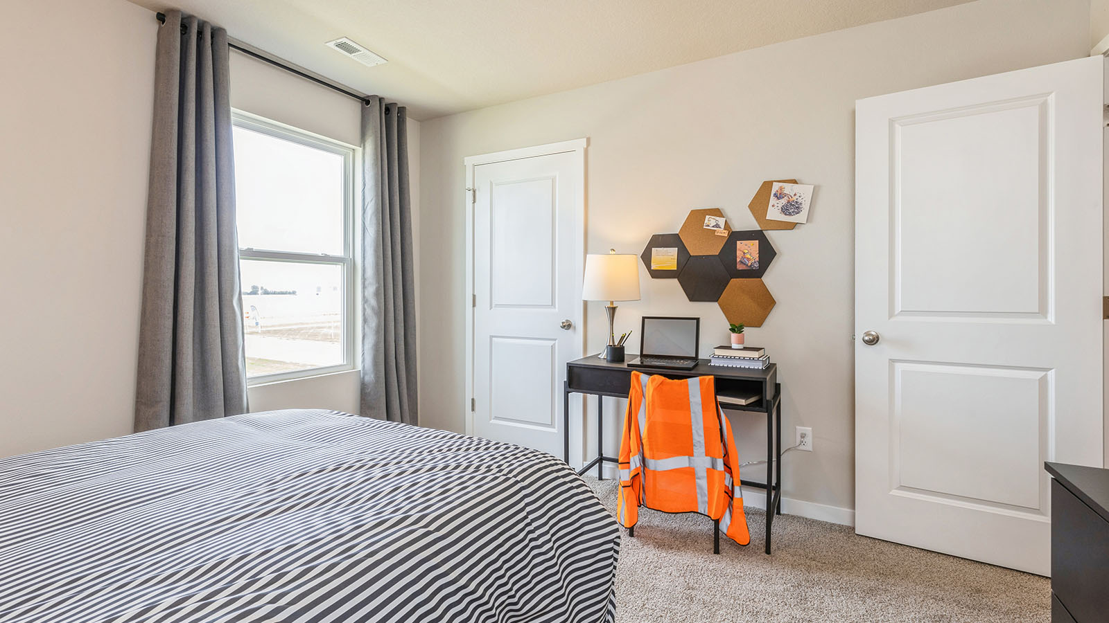 Comfortable secondary bedroom with natural light, modern finishes, and versatile living space.