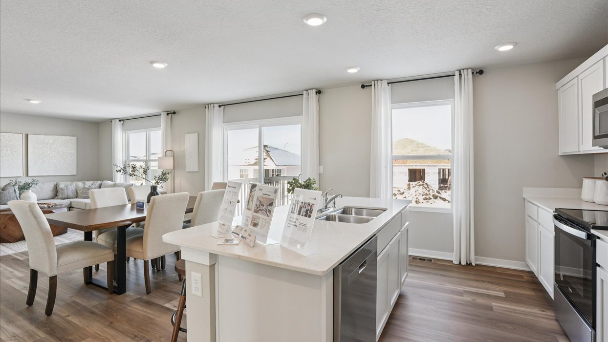 Kitchen with stainless steel appliances, quartz countertops, and white cabinetry