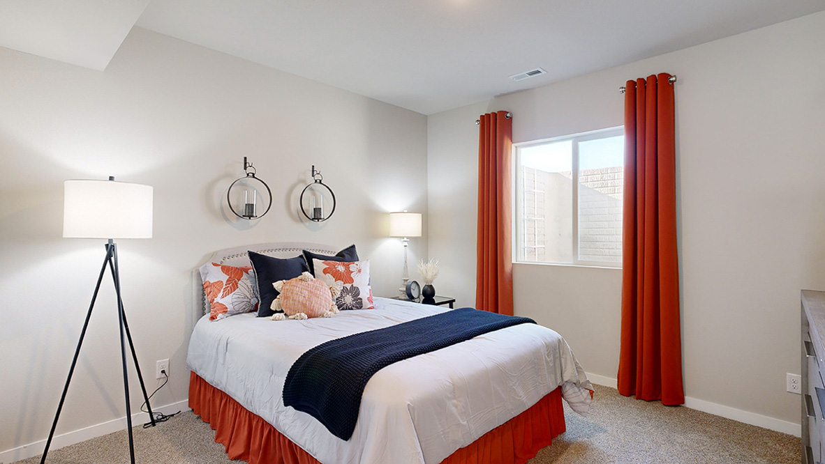 Private lower-level bedroom with natural light and functional storage space.