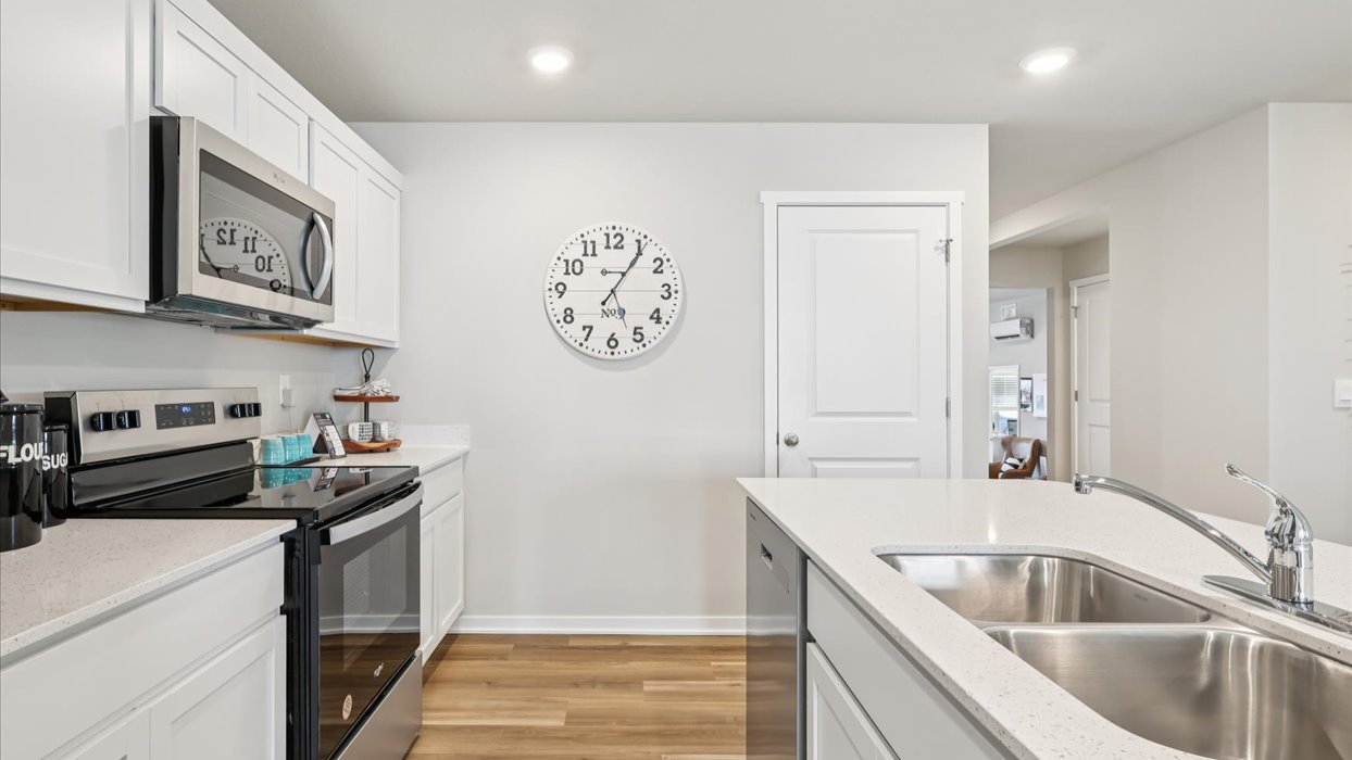 Kitchen with white cabinetry and quartz countertop