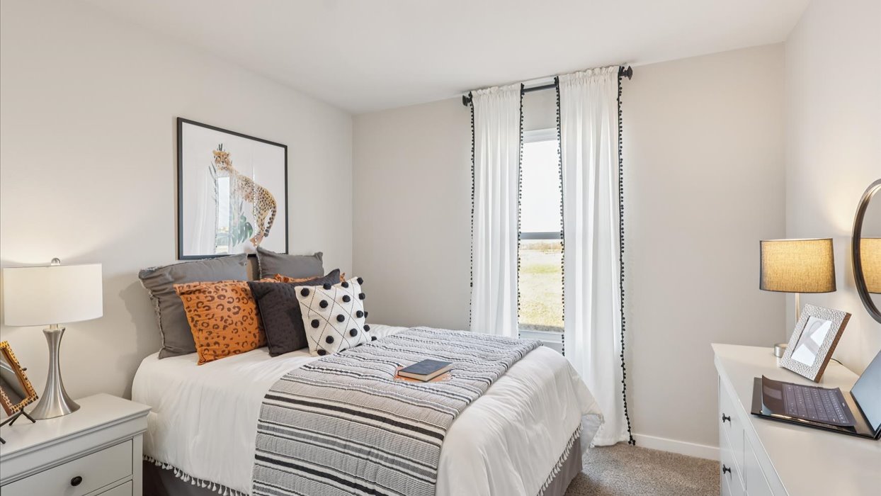 Comfortable secondary bedroom with natural light, modern finishes, and versatile living space.