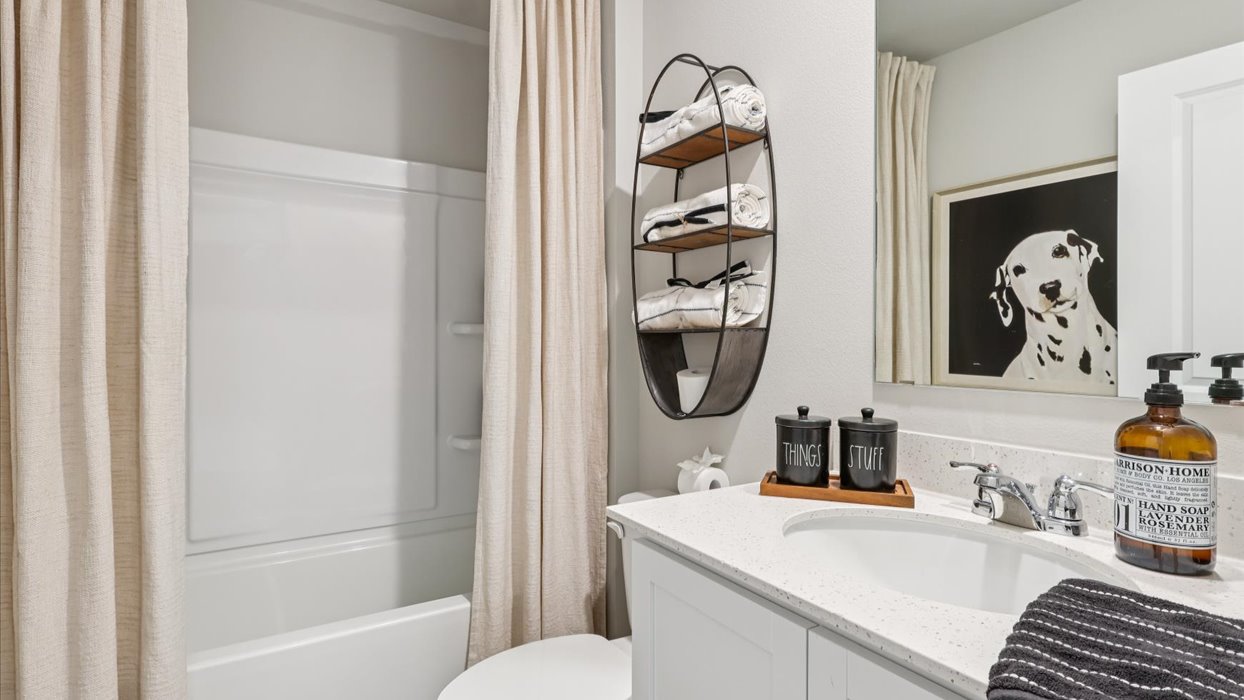 Stylish full bathroom with bright lighting and functional design.
