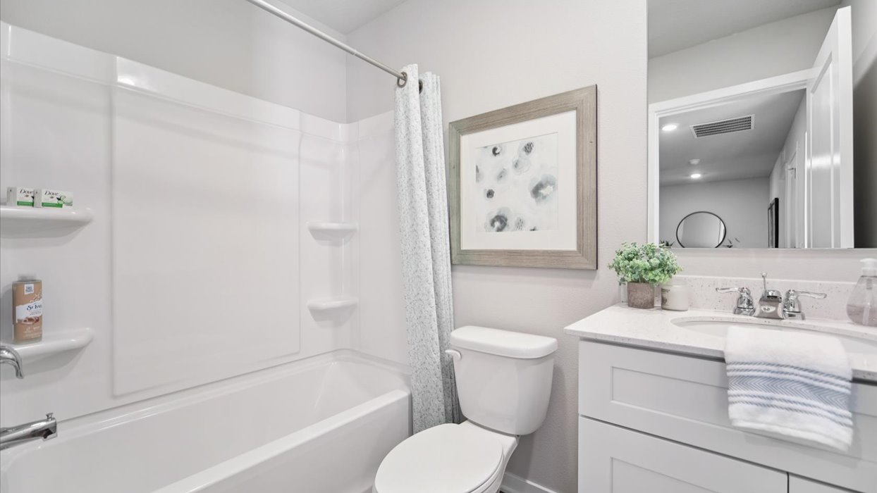Stylish full bathroom with bright lighting and functional design.