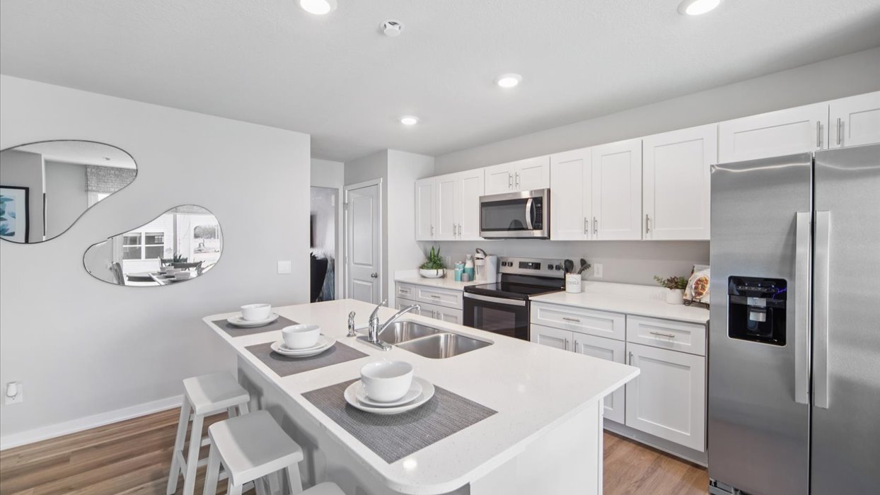 Kitchen with white cabinetry and quartz countertop