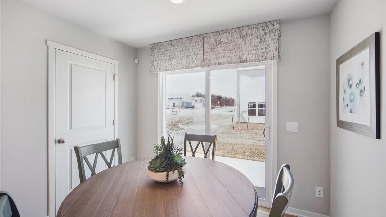 Open concept dining space with access to backyard