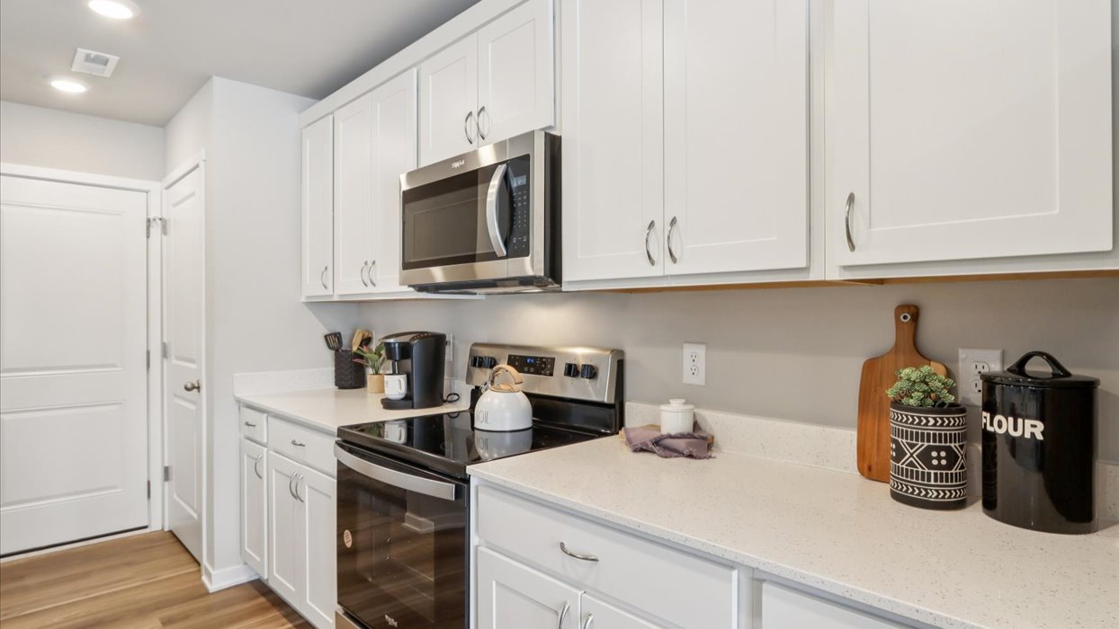 Kitchen with white cabinetry and quartz countertop