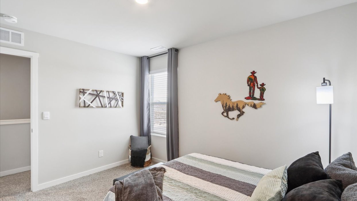 Comfortable secondary bedroom with natural light, modern finishes, and versatile living space.