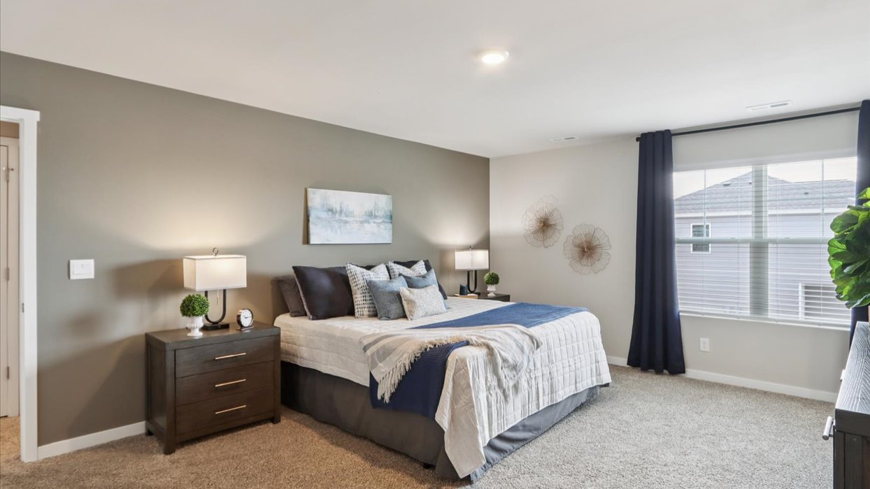 Primary bedroom with natural lighting and spacious layout