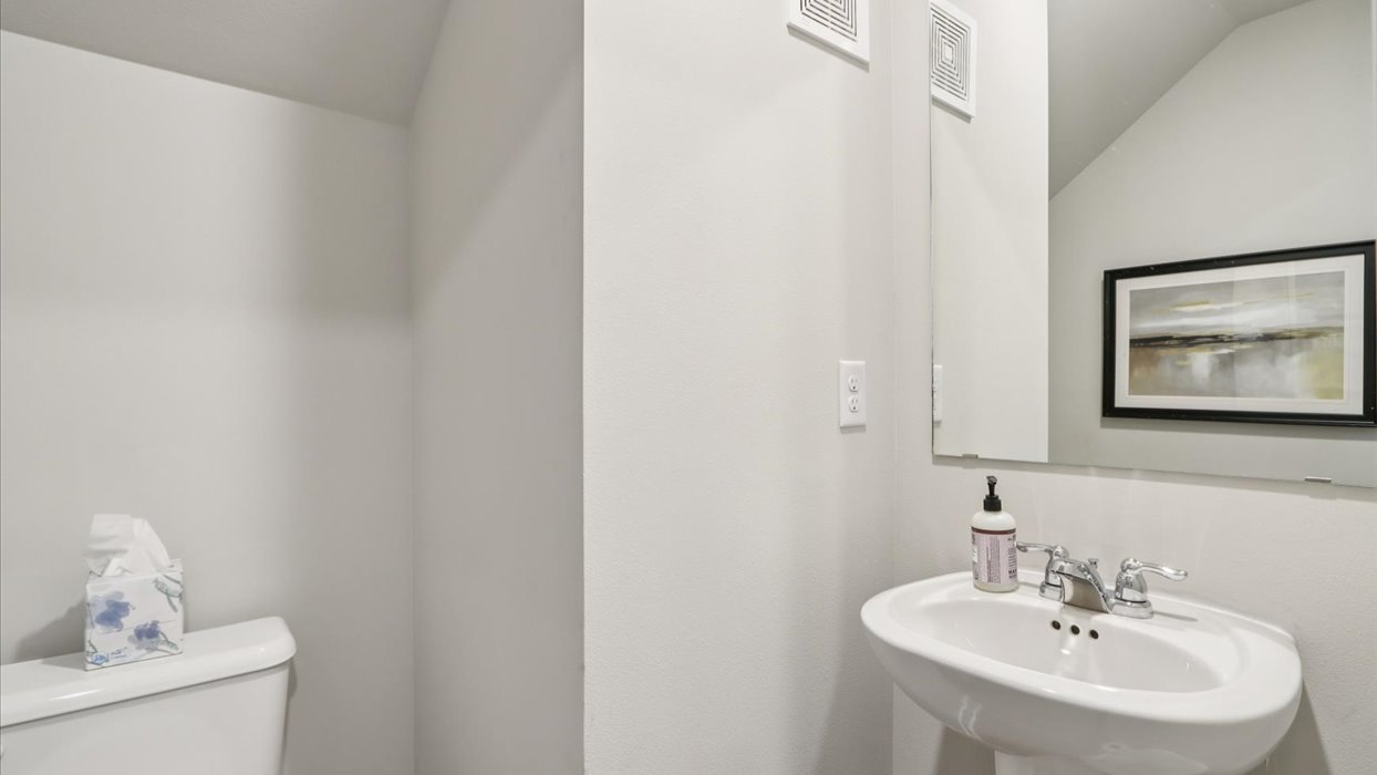 Convenient main-level powder room with updated fixtures and bright lighting.
