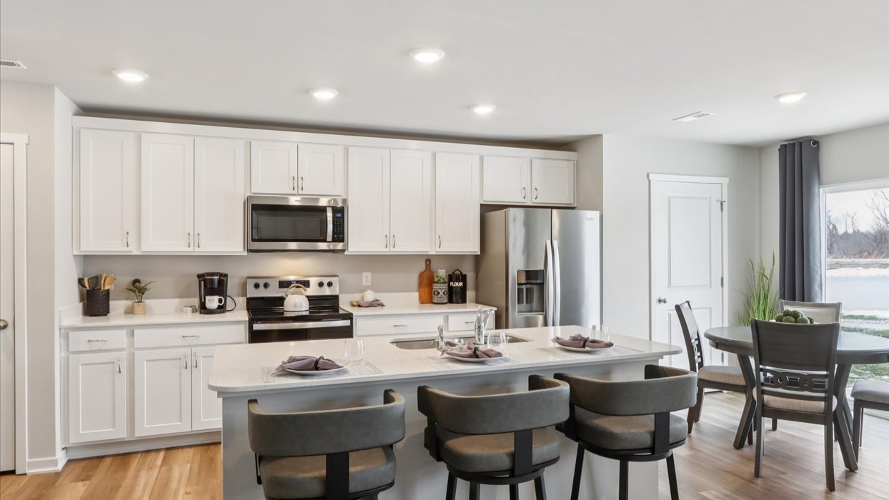 Kitchen with white cabinetry and quartz countertop