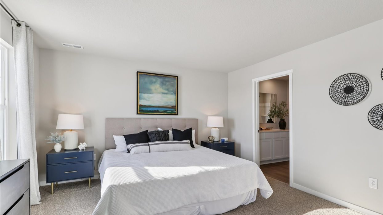 Primary bedroom with natural lighting and spacious layout