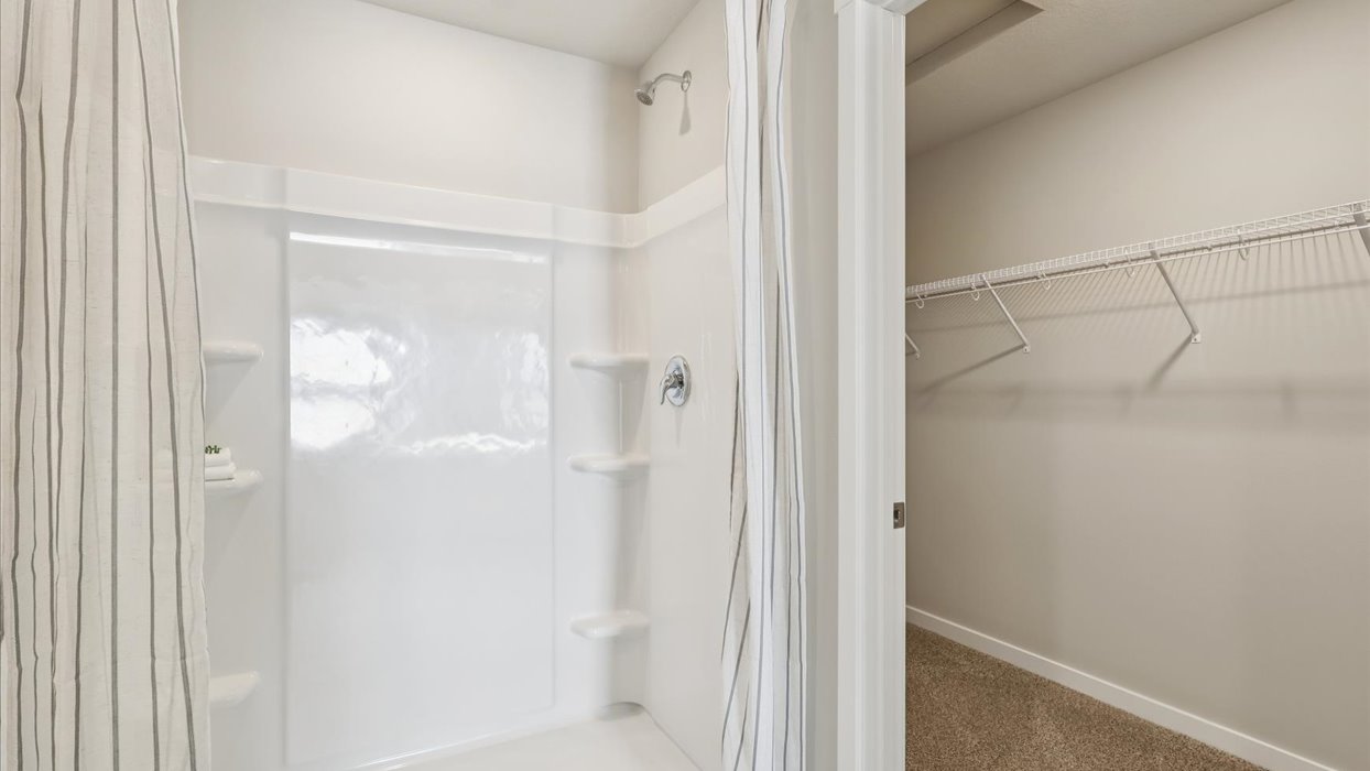 Spacious bathroom with white cabinetry and double sinks